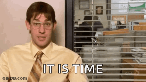 A Man In A Yellow Shirt And Tie Is Sitting In Front Of A Window And Says `` It Is Time '' . GIF