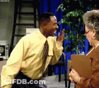 A Man In A Yellow Shirt And Tie Is Talking To An Older Woman While Holding A Clipboard GIF