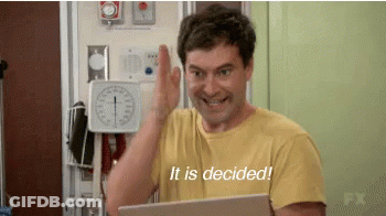 A Man In A Yellow Shirt Is Giving A High Five While Holding A Laptop And Says It Is Decided . GIF
