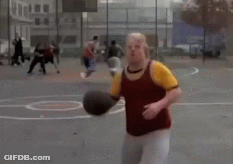 A Man In A Yellow Shirt Is Holding A Basketball In His Hands While Playing Basketball . GIF