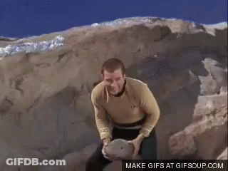 A Man In A Yellow Shirt Is Holding A Basketball Over His Head .. GIF