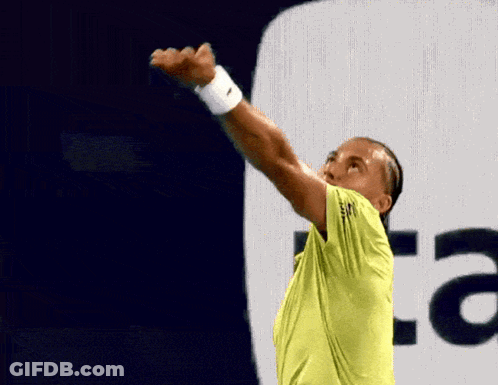 A Man In A Yellow Shirt Is Holding A Tennis Racket In Front Of An Au Logo GIF