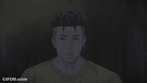 A Man In A Yellow Shirt Is Looking At The Camera With His Hands Folded . GIF