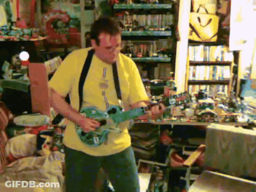 A Man In A Yellow Shirt Is Playing A Blue Guitar GIF