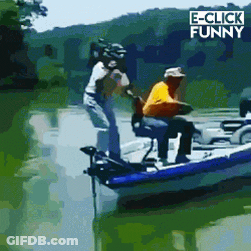 A Man In A Yellow Shirt Is Sitting In A Boat With E-Click Funny Written In The Corner GIF