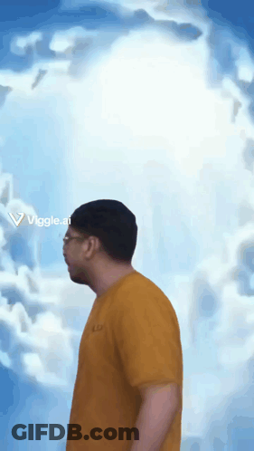 A Man In A Yellow Shirt Is Standing In Front Of A Cloudy Sky With The Letters Viggle.ai On The Bottom GIF