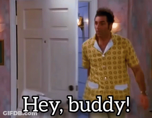 A Man In A Yellow Shirt Is Standing In Front Of A Door And Says Hey Buddy GIF