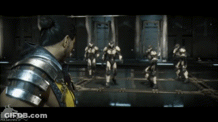 A Man In A Yellow Shirt Is Standing In Front Of A Group Of Robots GIF
