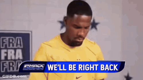 A Man In A Yellow Shirt Is Standing In Front Of A Sign That Says We 'Ll Be Right Back GIF
