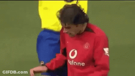 A Man In A Yellow Shirt Is Standing Next To A Man In A Red Shirt . GIF