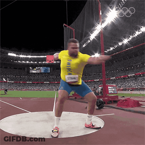 A Man In A Yellow Shirt Is Throwing A Disc GIF