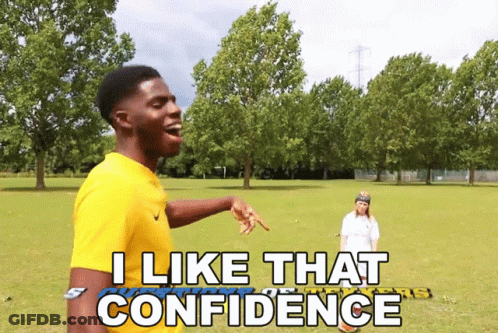 A Man In A Yellow Shirt Says I Like That Confidence In A Park GIF