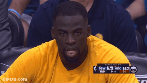 A Man In A Yellow Shirt Sits In The Stands Watching A Game Between Gsw And Okc GIF