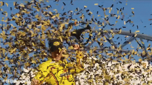 A Man In A Yellow Shirt That Says ' Hawaii ' On It Is Surrounded By Confetti GIF