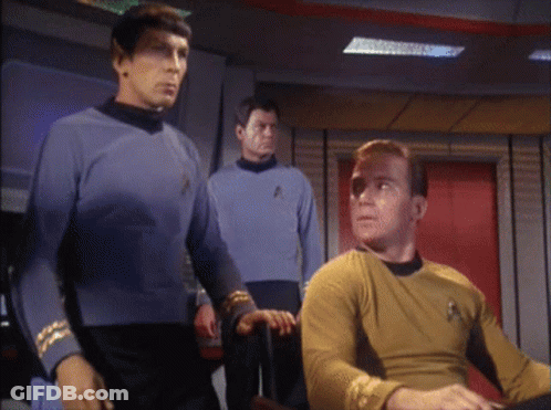 A Man In A Yellow Shirt With The Star Trek Logo On It GIF