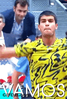 A Man In A Yellow Shirt With The Word Vamos On The Bottom GIF