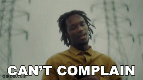 A Man In A Yellow Shirt With The Words Can 'T Complain Below Him GIF