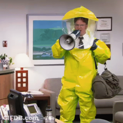 A Man In A Yellow Suit Holds A Megaphone In His Mouth GIF
