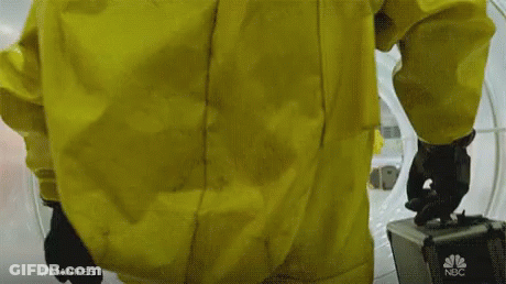A Man In A Yellow Suit Is Holding A Briefcase With Nbc On It GIF