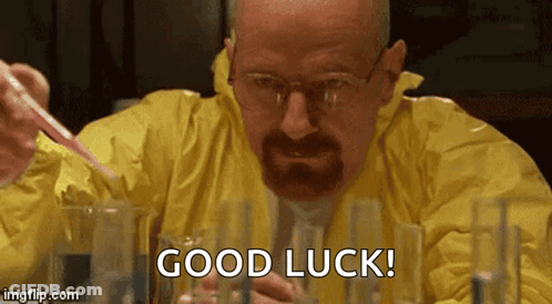 A Man In A Yellow Suit Is Holding A Pipette And Saying Good Luck GIF