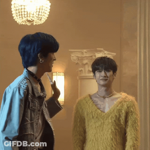 A Man In A Yellow Sweater Is Standing Next To A Man In A Blue Jacket GIF