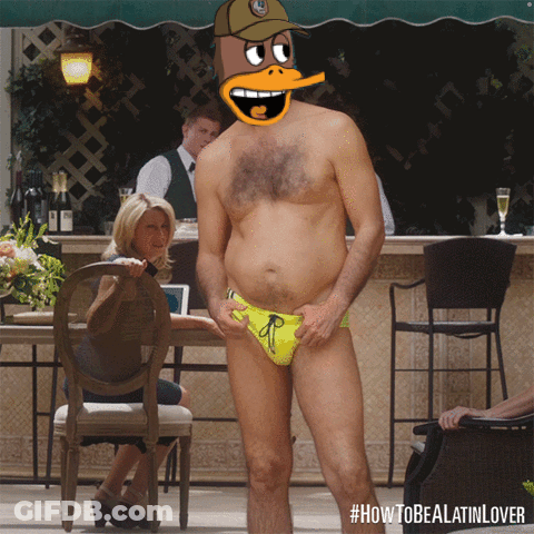 A Man In A Yellow Swim Suit With A Cartoon Duck On His Head GIF