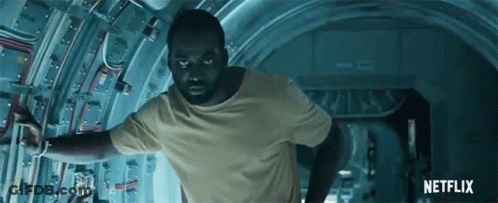 A Man In A Yellow T-Shirt Is Running Through A Tunnel With A Netflix Logo In The Background GIF