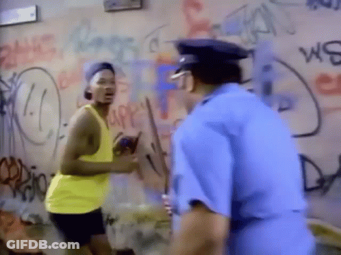 A Man In A Yellow Tank Top Is Standing Next To A Police Officer . GIF