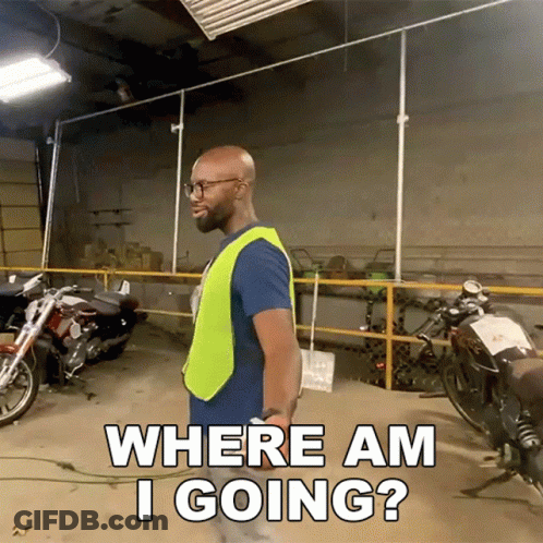 A Man In A Yellow Vest Is Standing In A Garage With Motorcycles And Asking Where Am I Going GIF