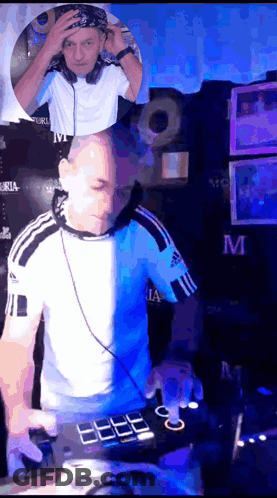 A Man In An Adidas Shirt Is Playing Music On A Mixer GIF