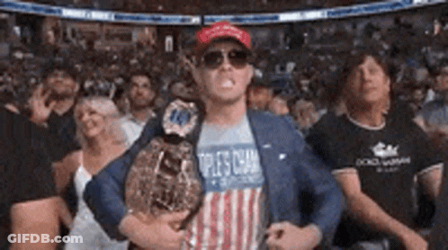 A Man In An American Flag Shirt Is Holding A Boxing Championship Belt . GIF