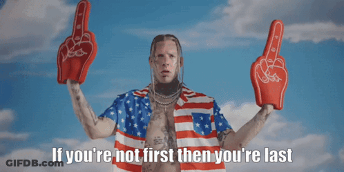 A Man In An American Flag Shirt Is Holding Up Boxing Gloves With The Words If You 'Re Not First Then You 'Re Last Below GIF