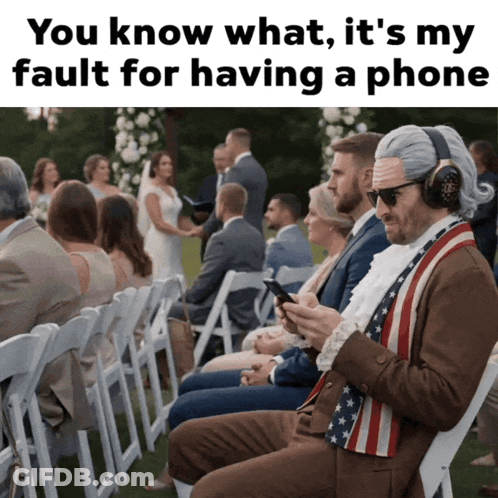 A Man In An American Flag Vest Is Looking At His Phone At A Wedding Ceremony GIF
