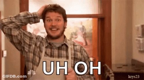 A Man In An Apron Is Scratching His Head While Wearing A Plaid Shirt And Smiling . GIF