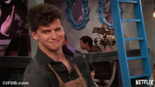 A Man In An Apron Is Smiling In Front Of A Blue Ladder That Says Netflix On It GIF