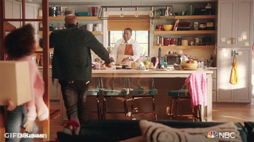 A Man In An Apron Is Standing In A Kitchen With A Nbc Logo On The Bottom GIF