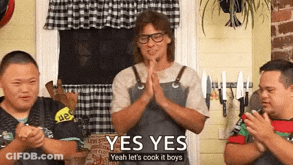 A Man In An Apron Is Standing In Front Of Two Boys With Down Syndrome And Clapping . GIF