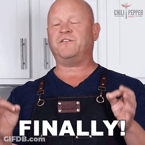 A Man In An Apron Says Finally With His Hands In The Air GIF