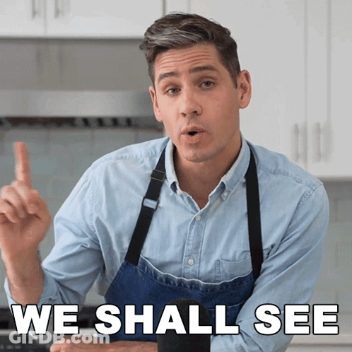 A Man In An Apron Says " We Shall See " In A Kitchen GIF
