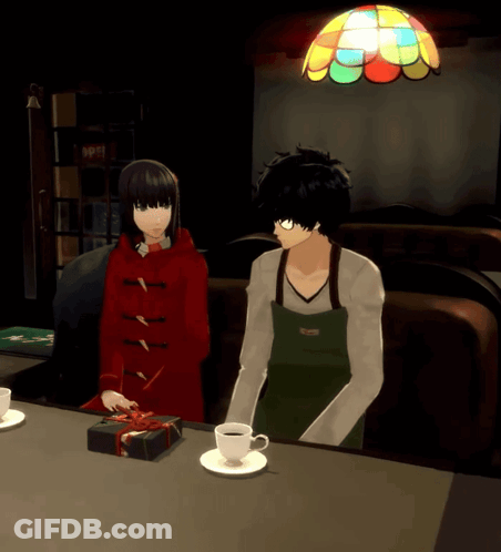 A Man In An Apron Sits Next To A Woman In A Red Coat GIF