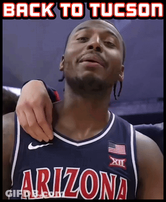 A Man In An Arizona Jersey Is Being Held By Another Man GIF
