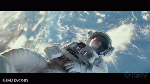 A Man In An Astronaut 'S Suit Is Floating In The Air GIF