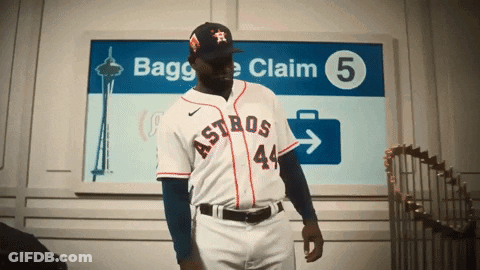 A Man In An Astros Uniform Is Standing In Front Of A Sign That Says Bagge Claim 5 GIF