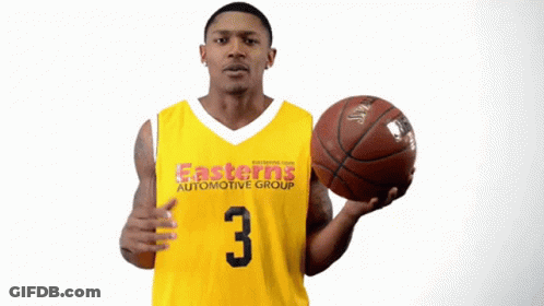 A Man In An Easterns Automotive Group Jersey Holding A Basketball GIF