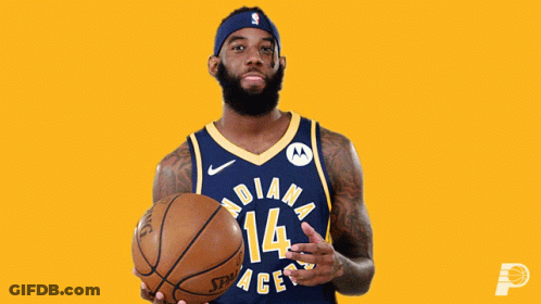 A Man In An Indiana Pacers Jersey Is Holding A Basketball GIF