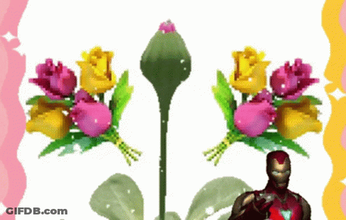 A Man In An Iron Man Suit Stands In Front Of Flowers GIF