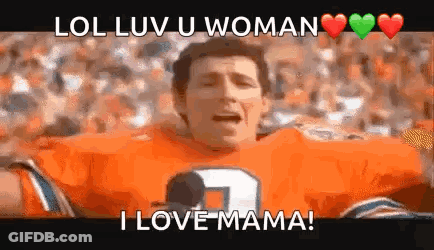 A Man In An Orange Football Jersey Is Holding A Microphone And Screaming . GIF