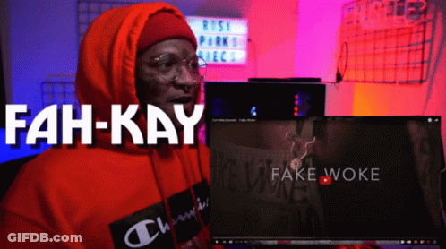 A Man In An Orange Hoodie Is Sitting In Front Of A Computer Screen That Says Fah-Kay GIF
