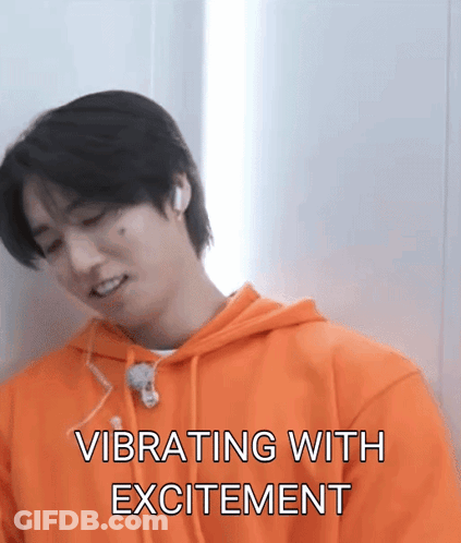 A Man In An Orange Hoodie Is Vibrating With Excitement GIF