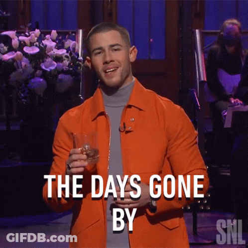 A Man In An Orange Jacket Holds A Glass Of Whiskey And Says The Days Gone By Snl GIF